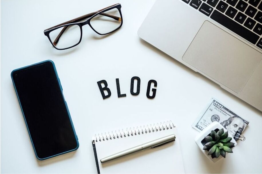 Modern workspace with laptop displaying the word "blog", symbolizing digital publishing in audio and tech